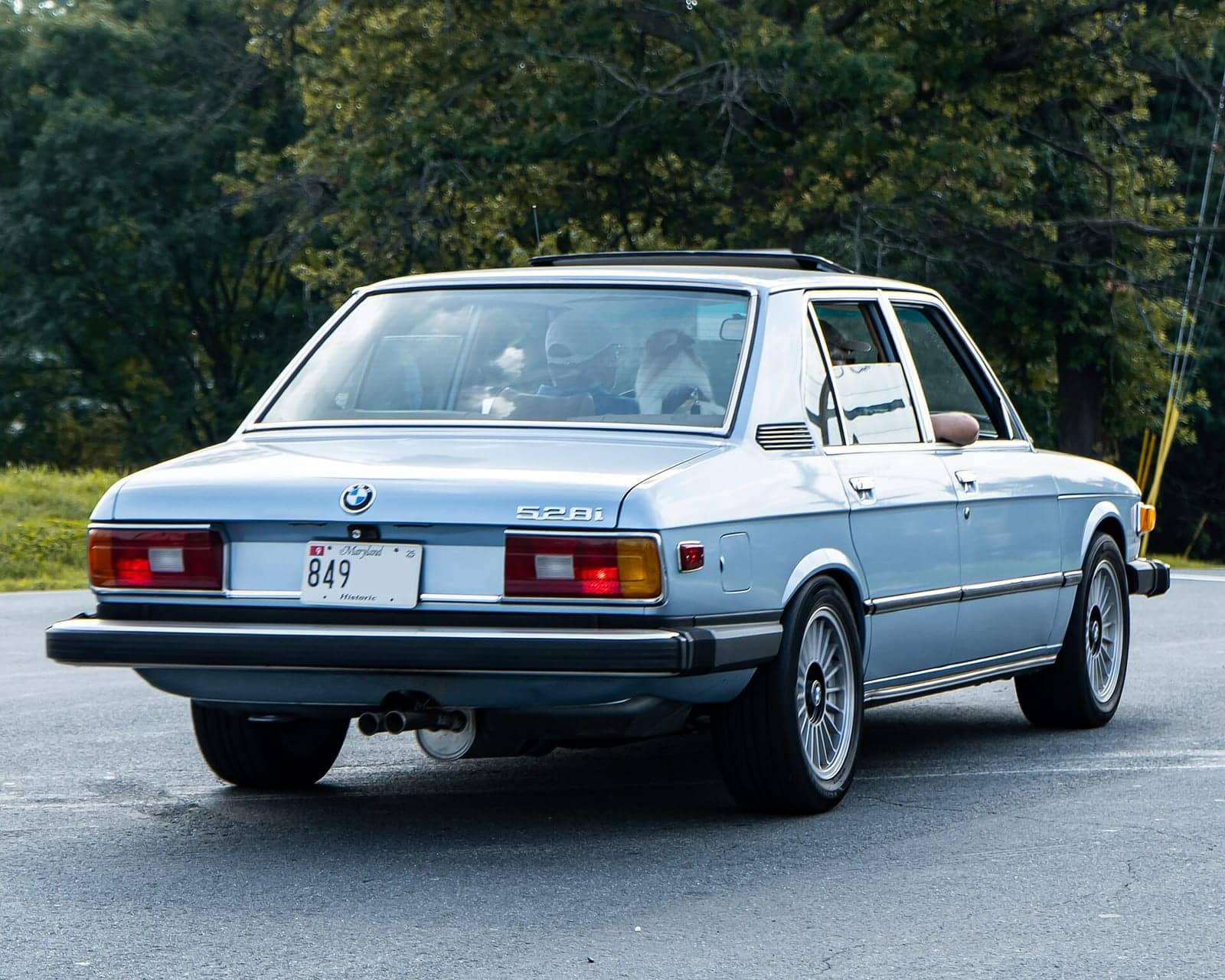 Light blue BMW 528i, rear view