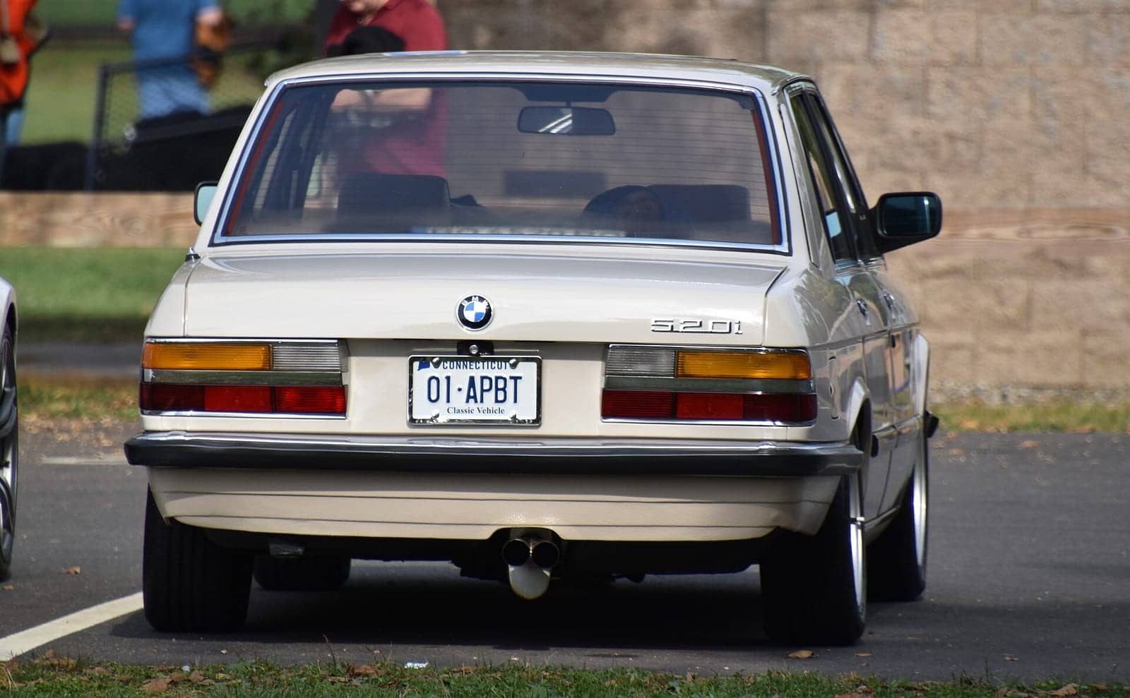 Beige BMW 520i, rear view