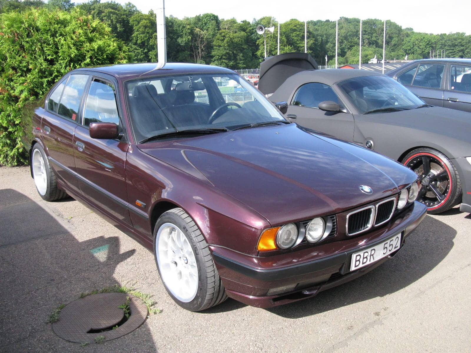 Dark purple BMW 540i, front three-quarter view