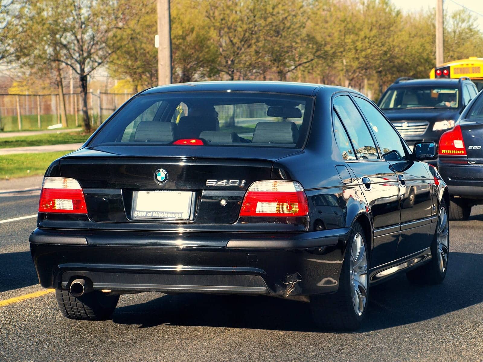 Black BMW 540i (facelift), rear three-quarter view