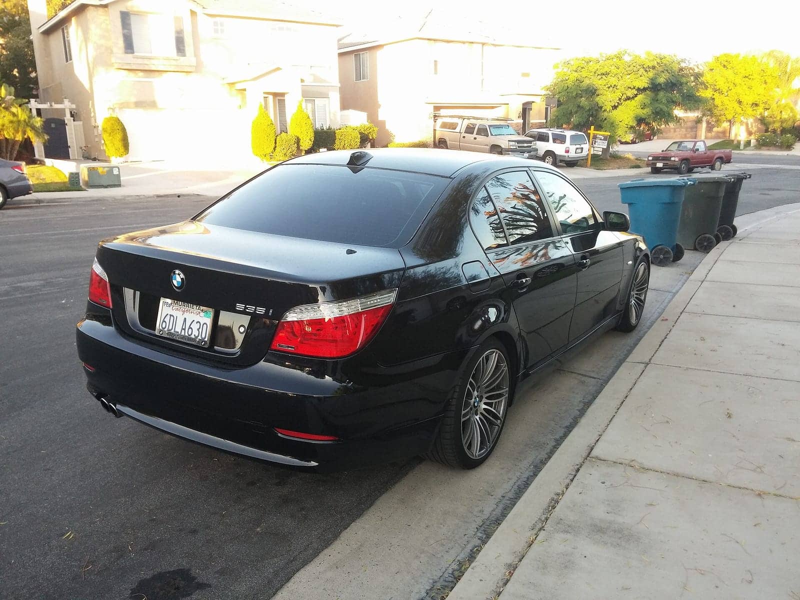 Black BMW 535i (facelift), rear three-quarter view