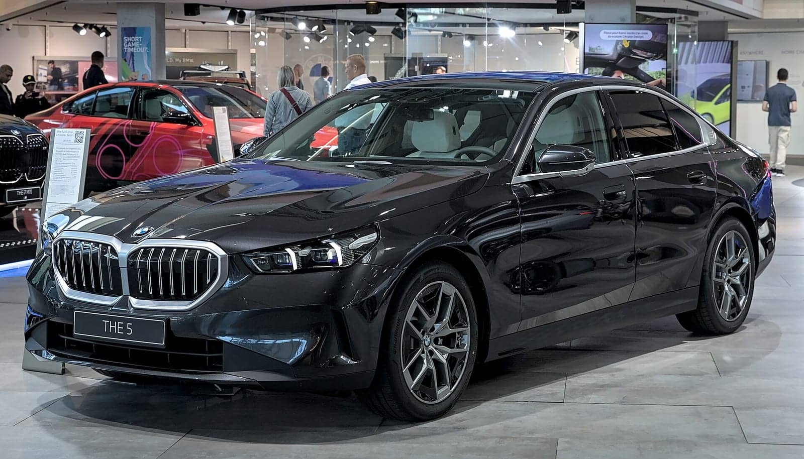 Black BMW 520d at a motor show, front three-quarter view