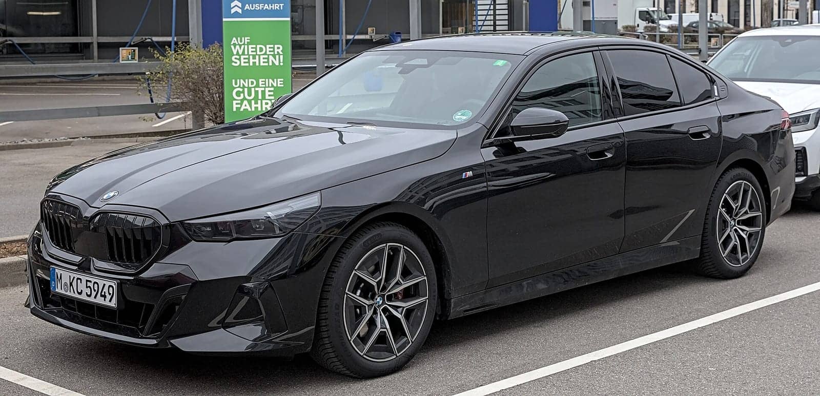 Black BMW 520i, front three-quarter view