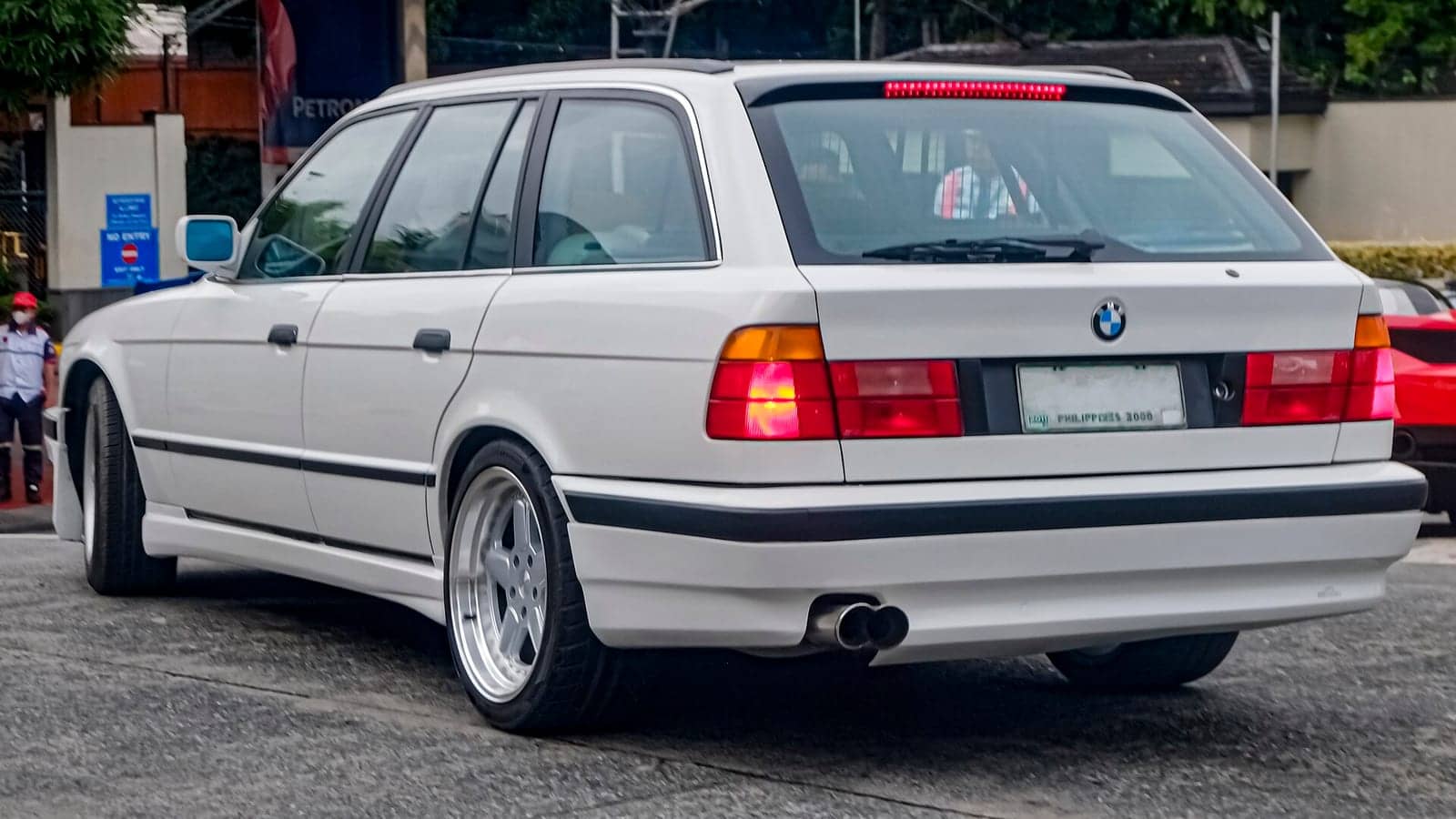 White BMW 525i Touring, rear three-quarter view