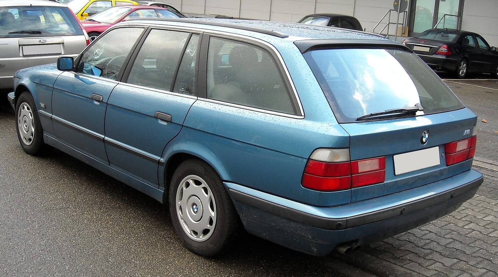 Light blue BMW 5 Series Touring (E34), rear three-quarter view