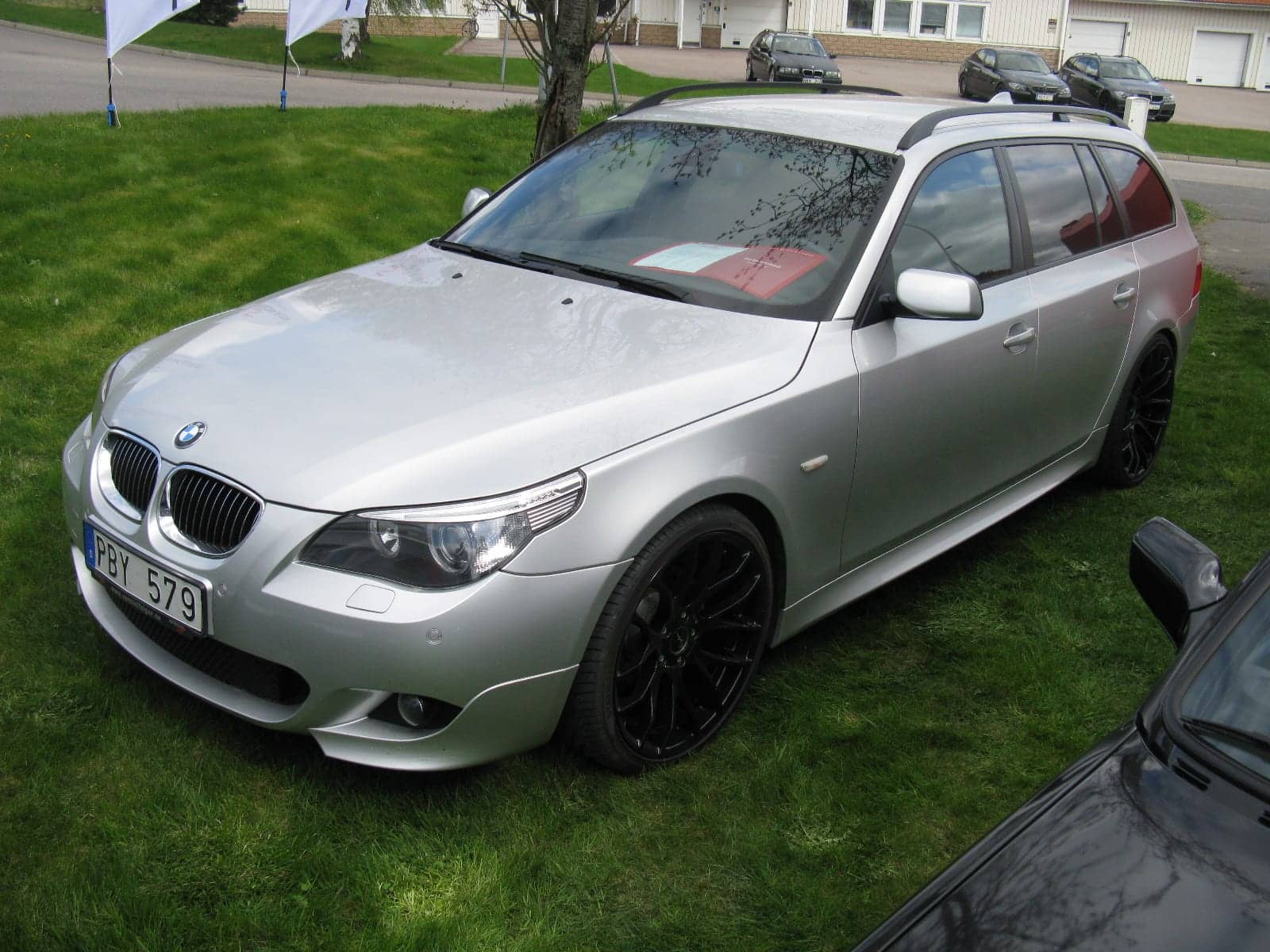 Silver BMW 523i Touring M Sport, front three-quarter view