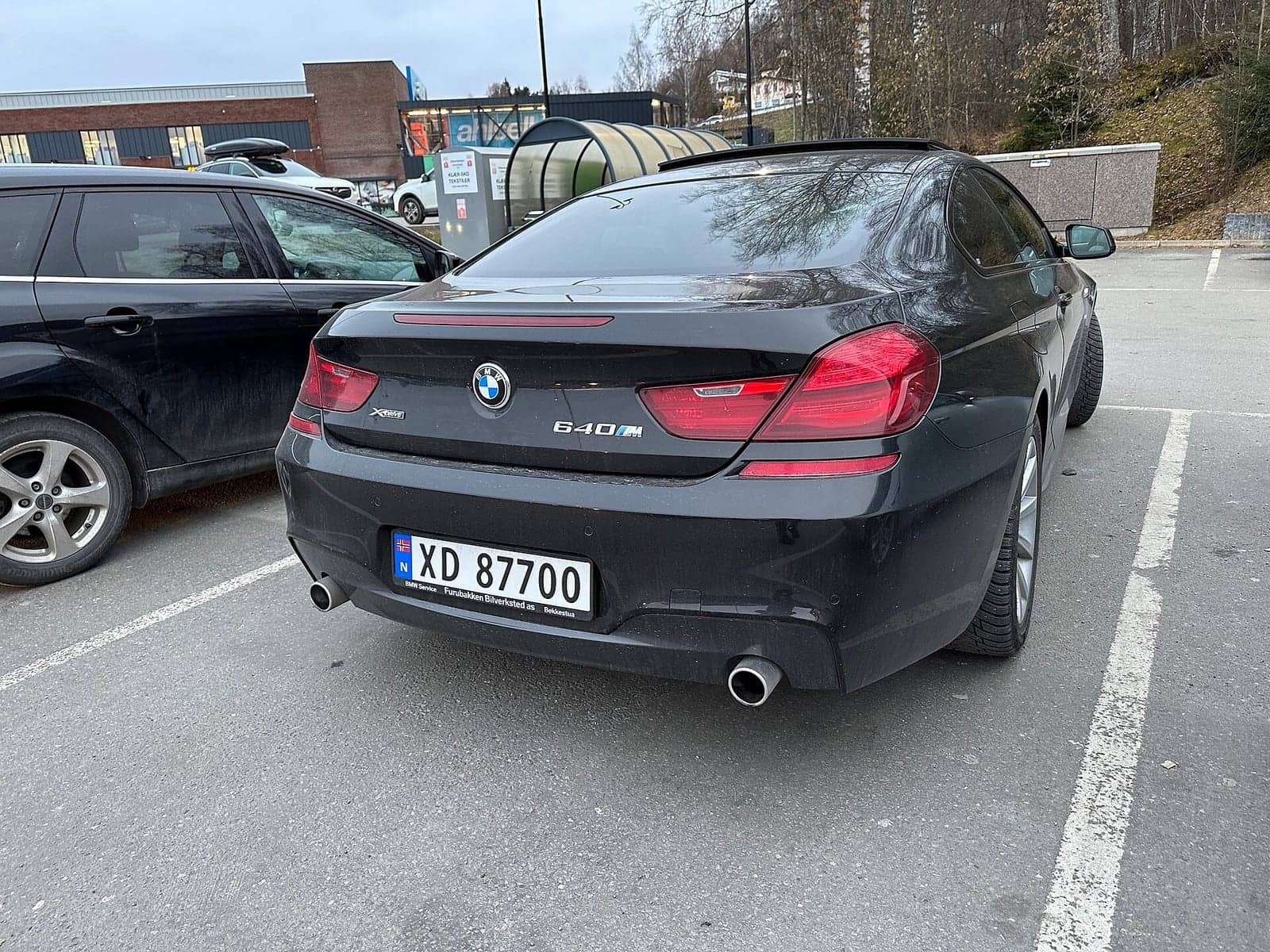 Black BMW 640d coupé, rear three-quarter view