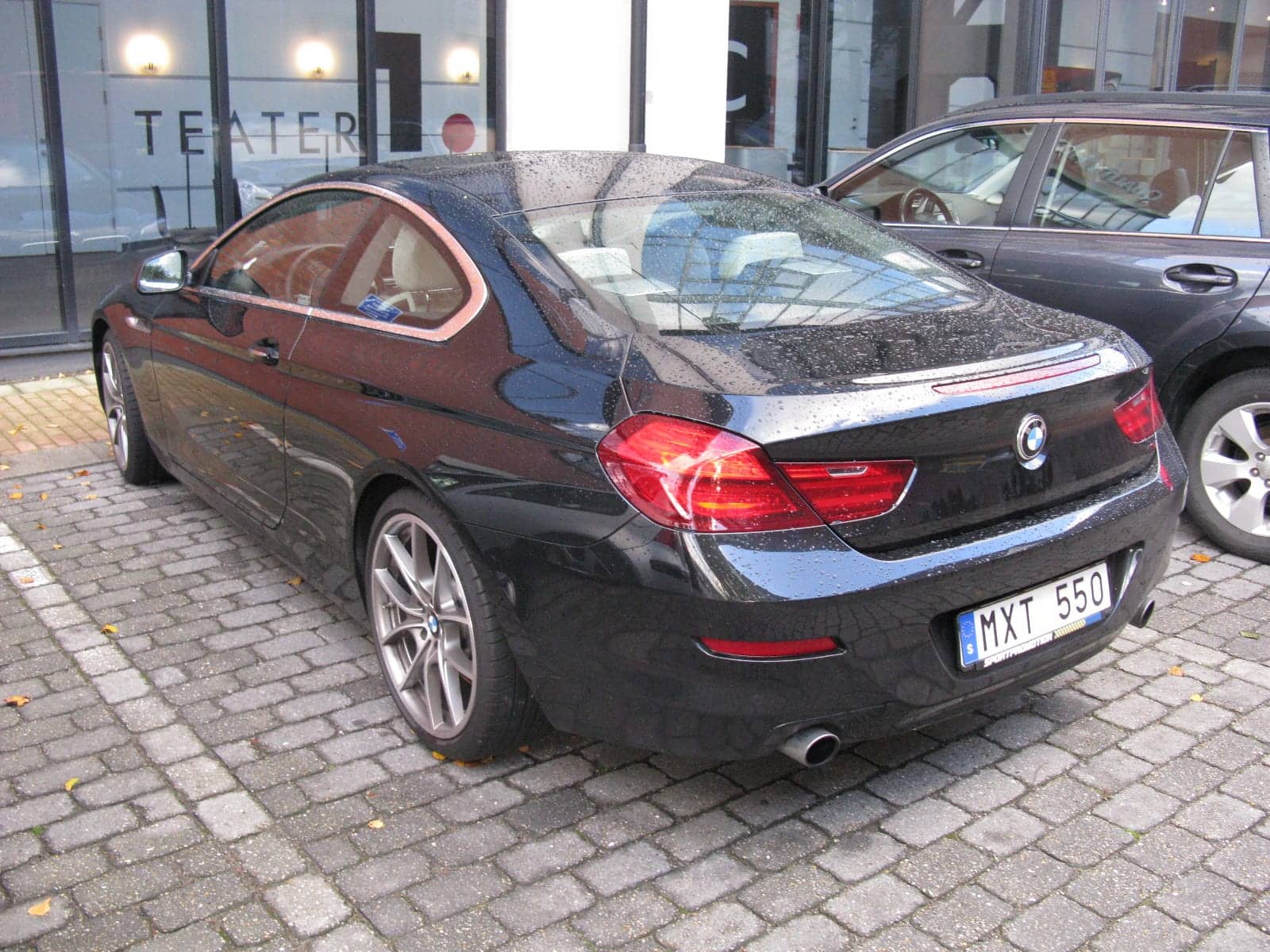 Black BMW 640i coupé, rear three-quarter view