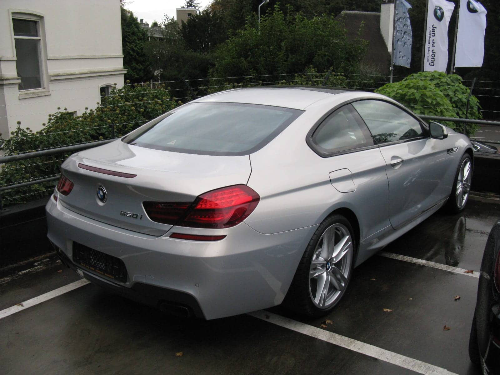 Silver BMW 650i M Sport coupé, rear three-quarter view