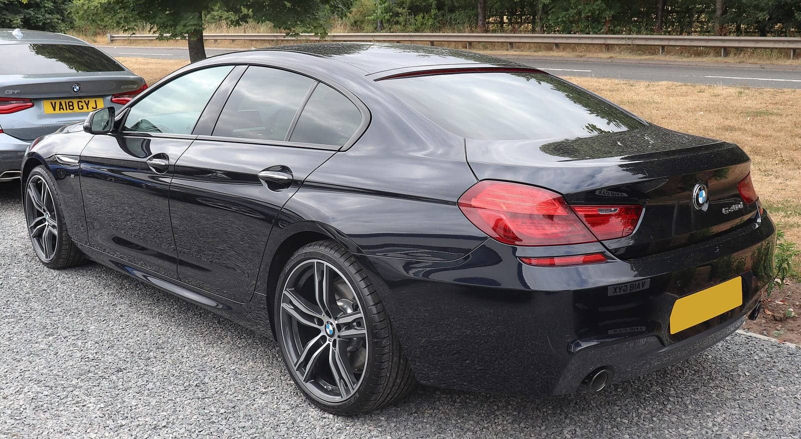 Black BMW 640 Gran Coupé (facelift), rear three-quarter view