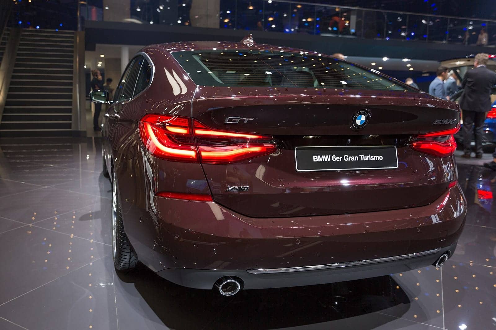 Burgundy BMW 630d xDrive Gran Turismo at a motor show, rear three-quarter view