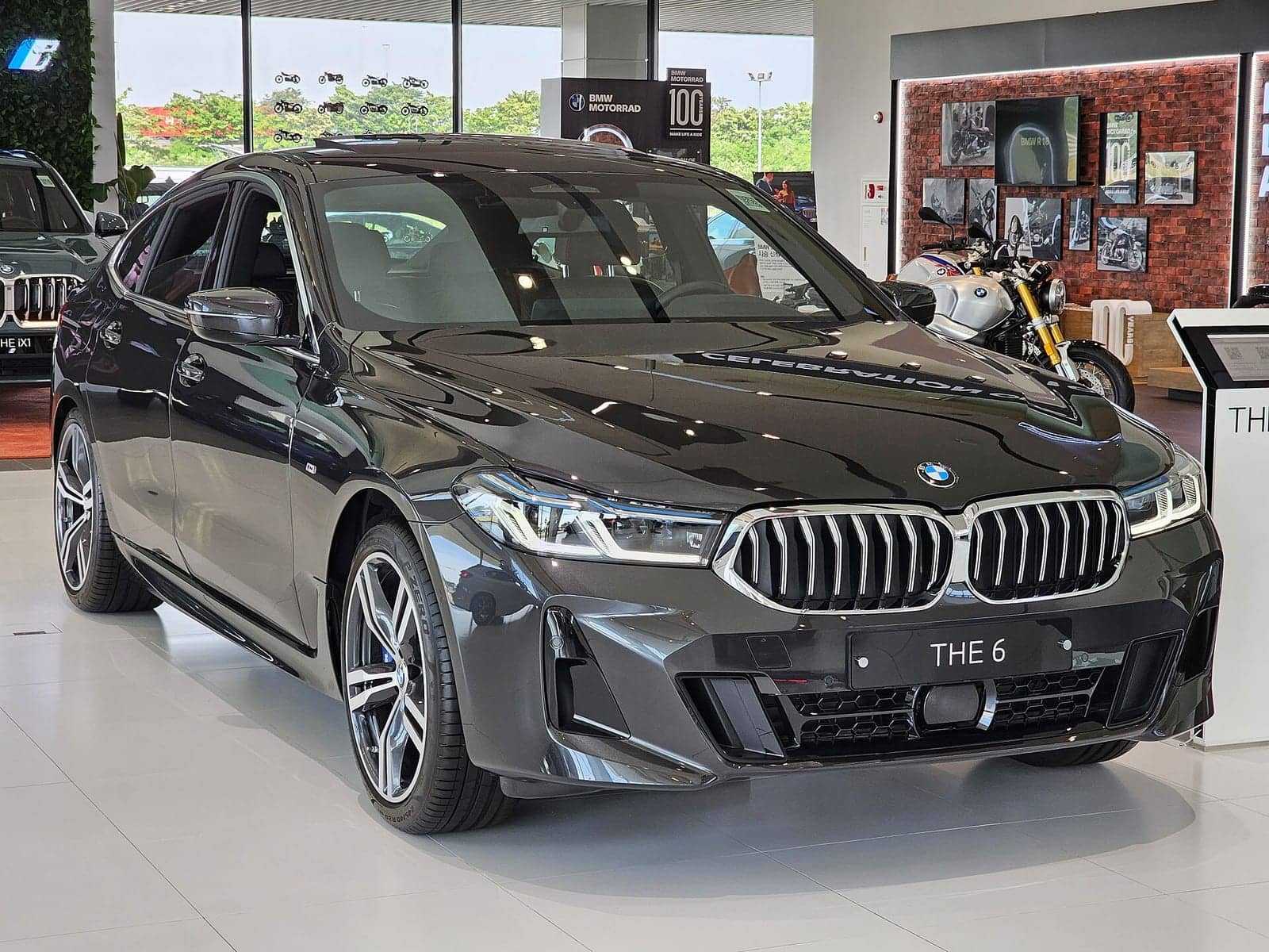 Grey BMW 640i xDrive Gran Turismo M Sport (facelift) in a showroom, front three-quarter view