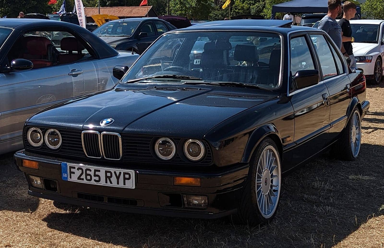 Black BMW 325i four-door (facelift), front three-quarter view