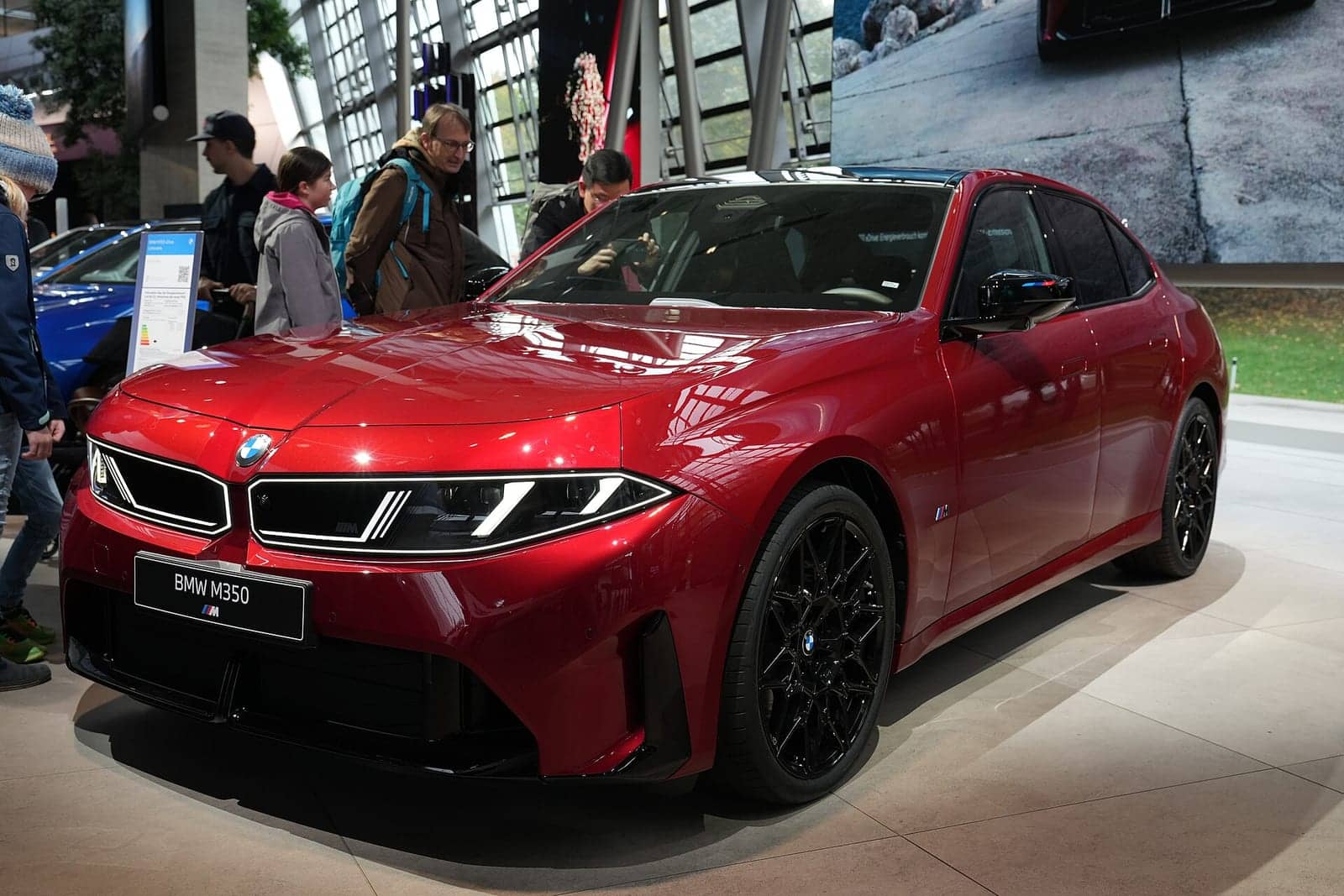 Red BMW M350 xDrive in the BMW Welt, front three-quarter view