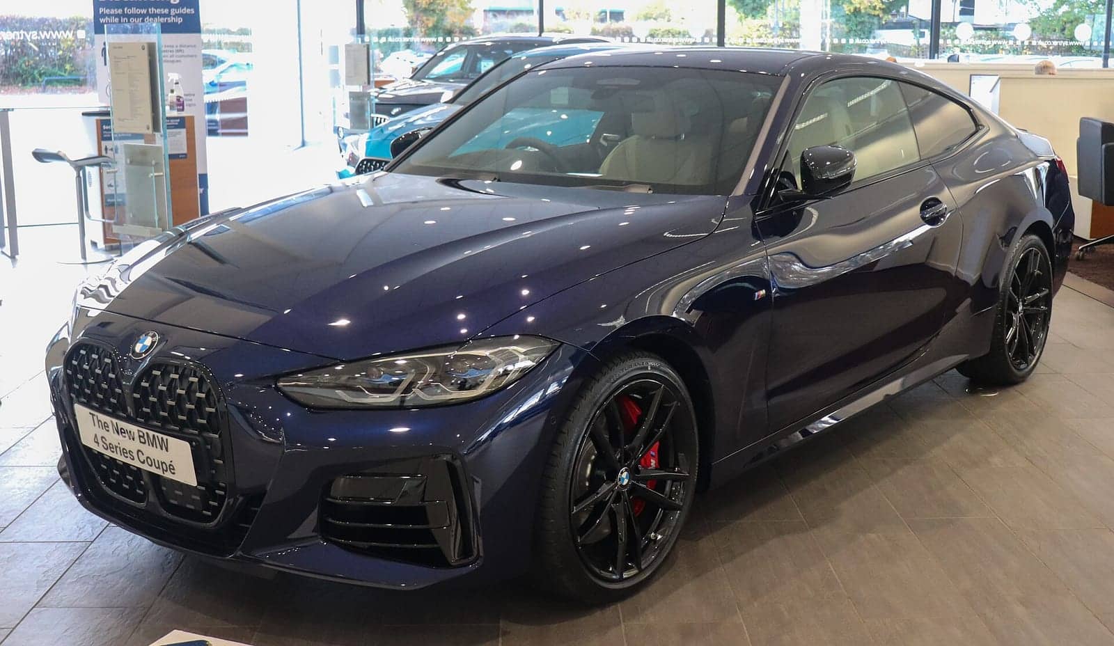 Blue BMW M440i xDrive coupé, front three-quarter view