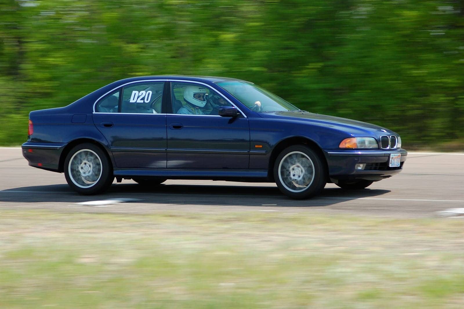Blue BMW 540i, side view